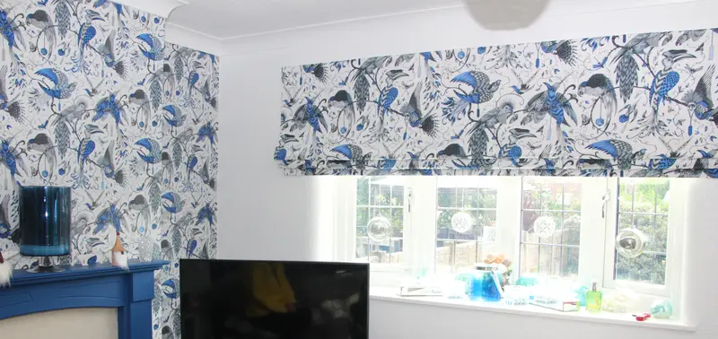 Blue floral Roman blinds in a bedroom by Heather Horrocks Leigh