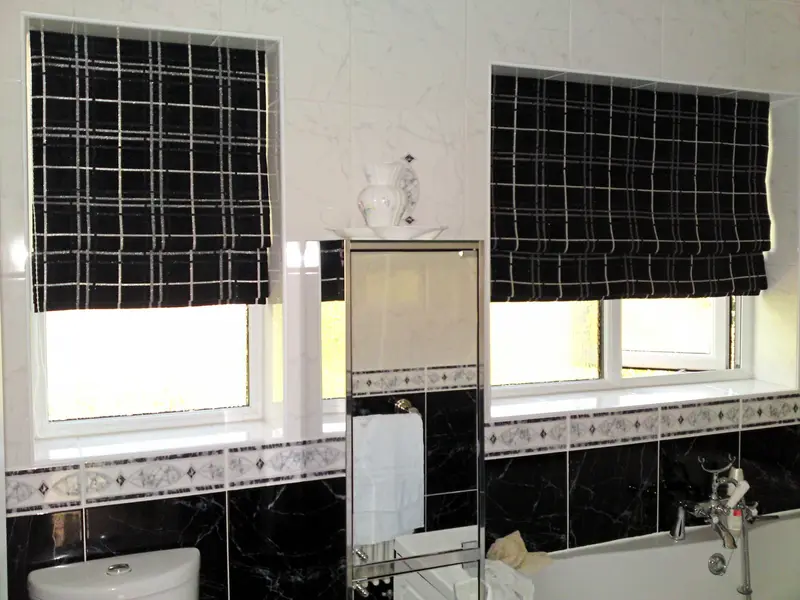 Black check Roman blinds in a bathroom by Heather Horrocks Leigh