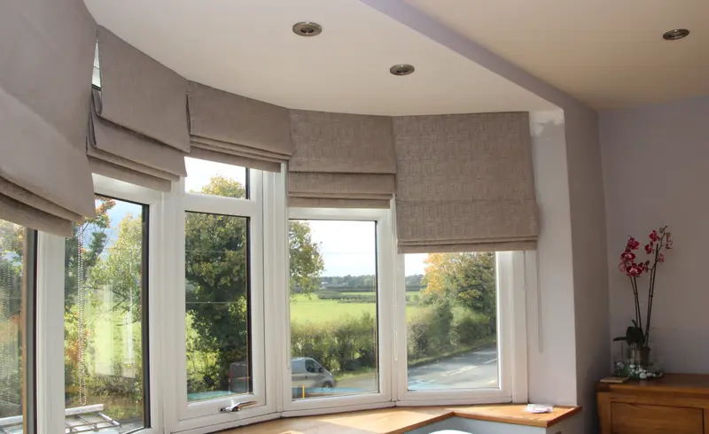 Roman blinds in a bay window by Heather Horrocks Leigh