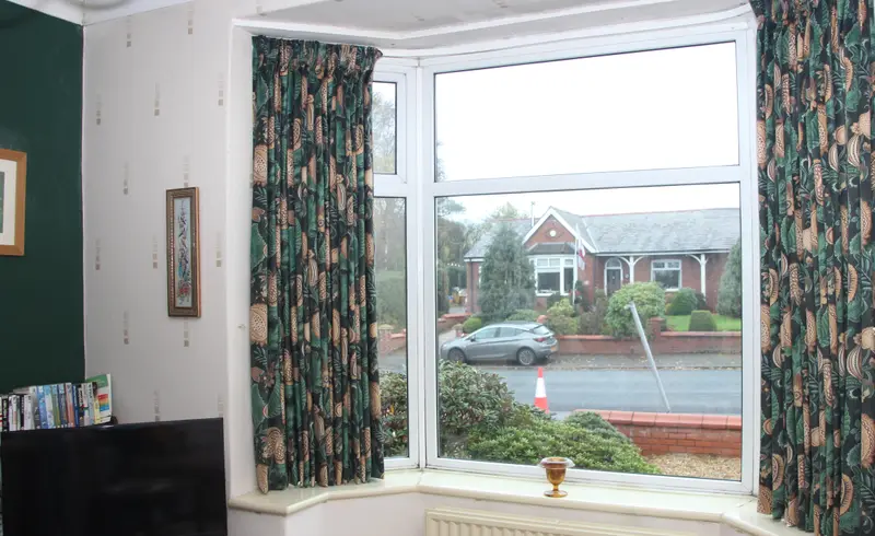 Green print curtains in a bay window by Heather Horrocks Leigh