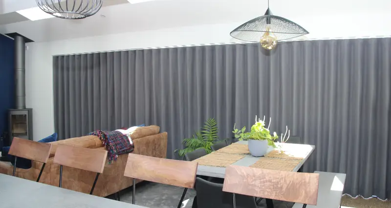 Grey wave curtains in an open plan dining room by Heather Horrocks Leigh